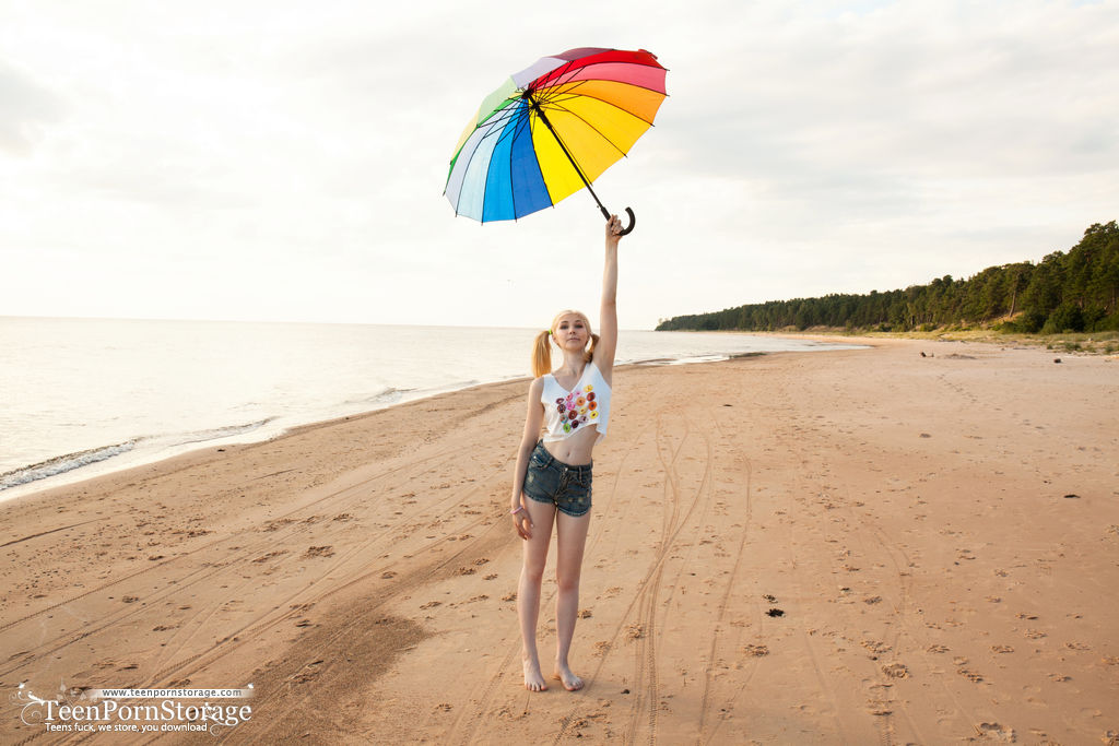 Blonde Teen Candy Holds An Umbrella Before A Nude Finger Fuck At The Beach