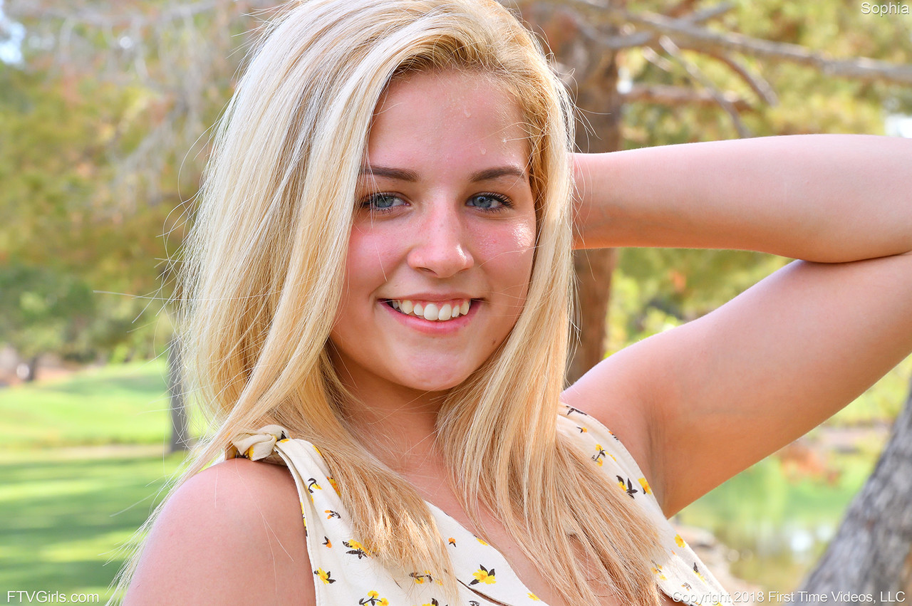 Blonde model lets her medium boobs loose in a public park porno foto #426950549