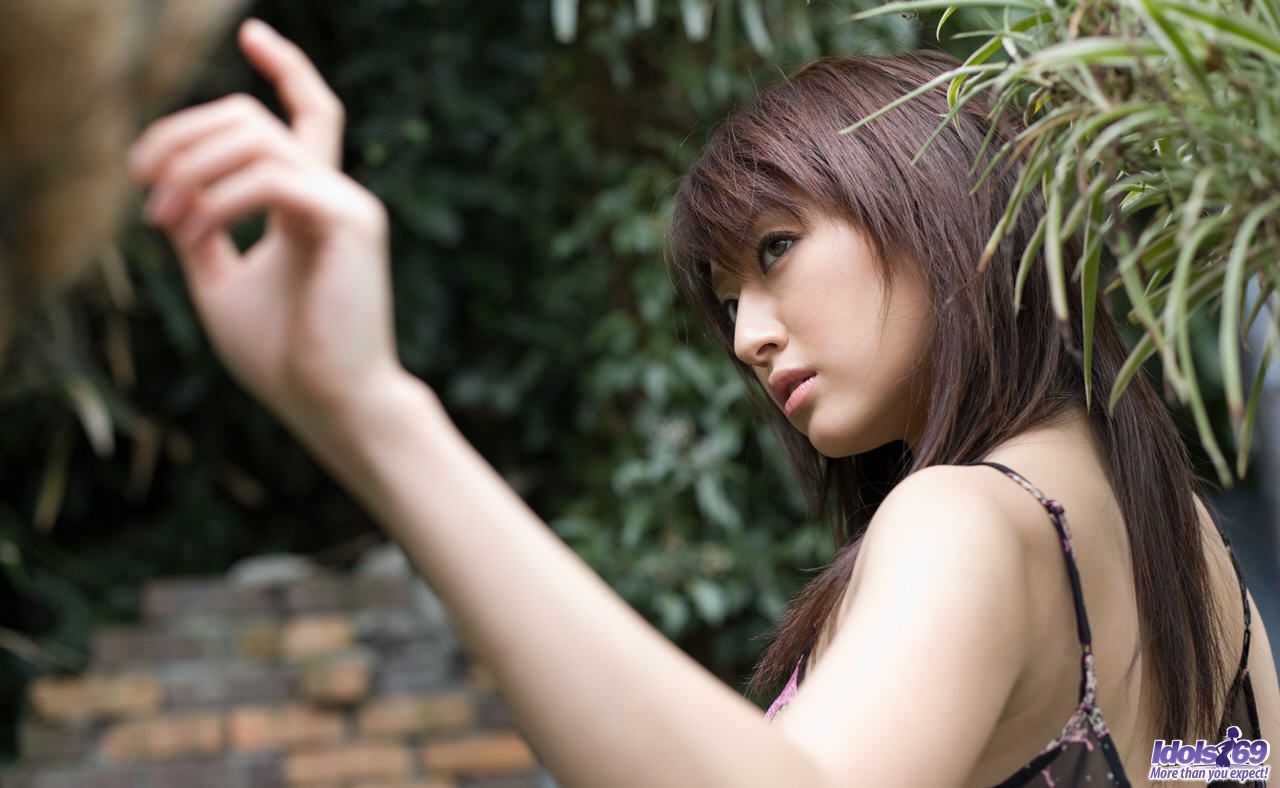 Japanese teen Misa Shinozaki pulls down her sheer panties in a garden porn photo #428402618