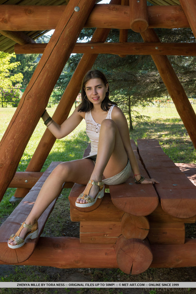 Young brunette Zhenya Mille disrobes for nude poses on picnic table porn photo #424725202
