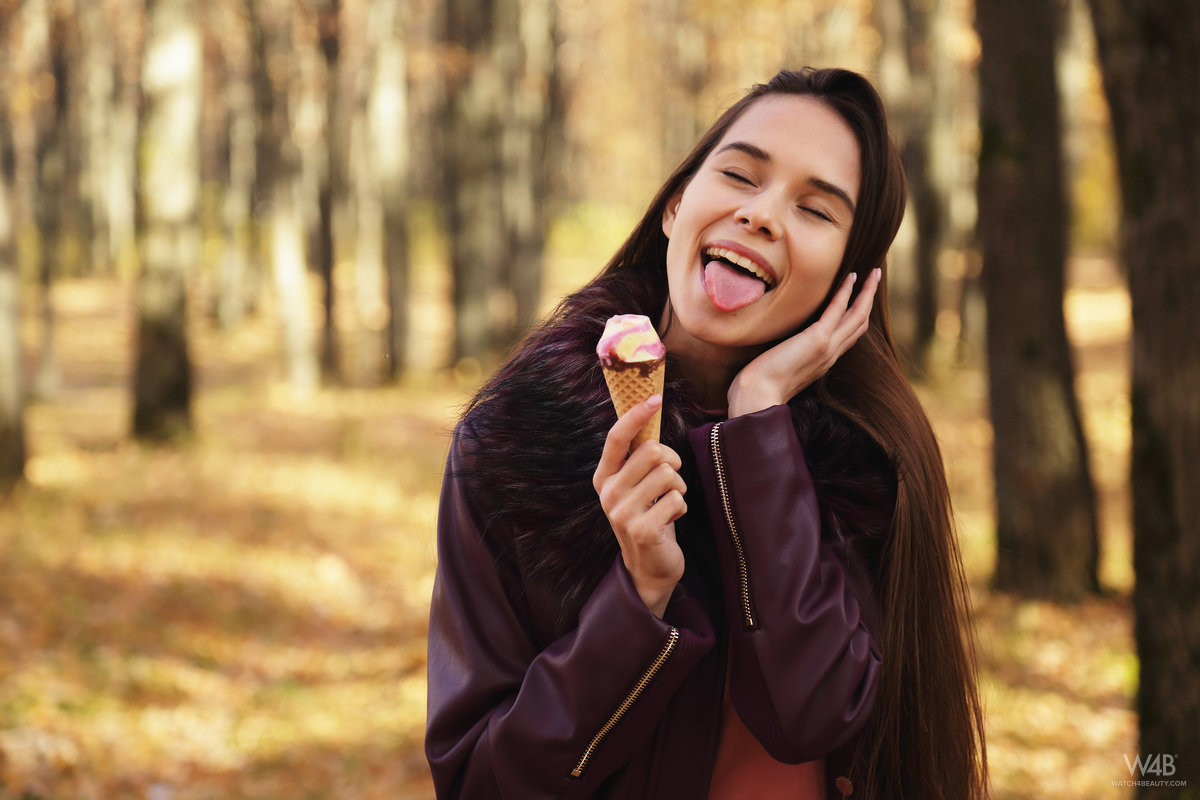 Nice Russian girl Leona Mia eats an ice cream treat in a forest while clothed porn photo #425268131