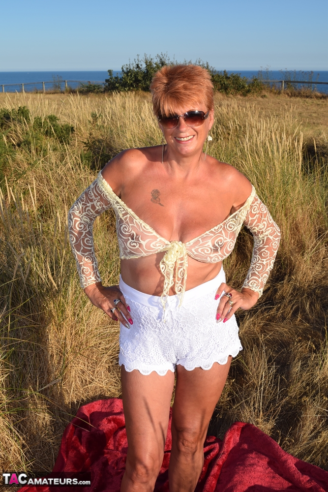 Despite the weather, Dimonty's fit and experienced older partner uncovers large natural phenomena on top of a blanket that overlooks the ocean.