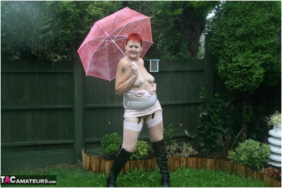 Older redhead Valgasmic Exposed models nude in the rain while holding a brolly porn photo #424895922