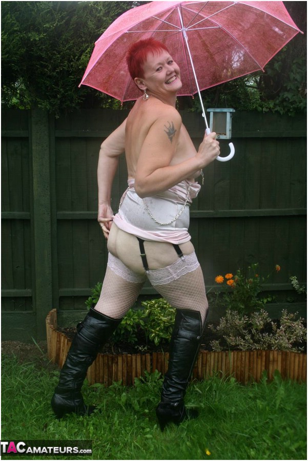 Older redhead Valgasmic Exposed models nude in the rain while holding a brolly porn photo #424895925