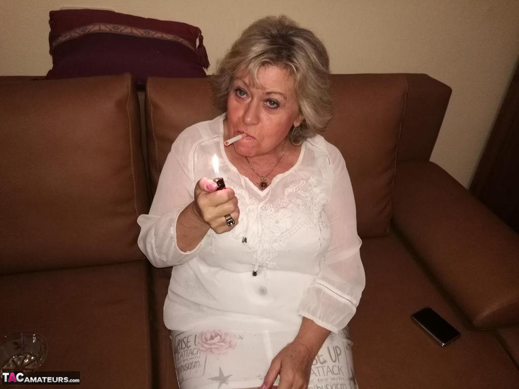 Mature Lady Exposes Her Large Tits While Having A Smoke In Pantyhose