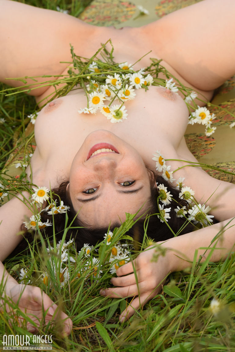 During her nude photoshoot, Jennifer selects wildflowers to decorate her bedroom with.