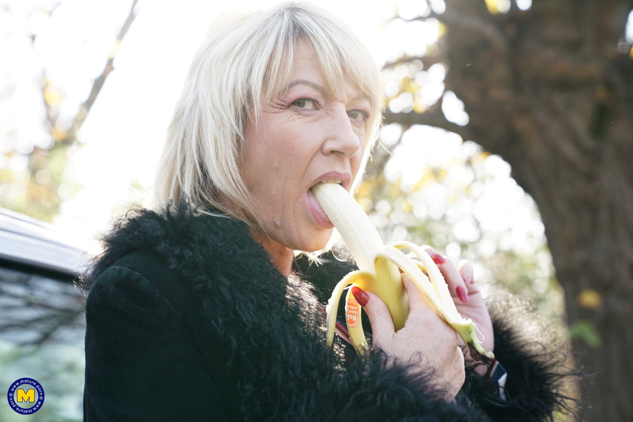 Mature Blonde Woman Eats A Banana Before A Gangbang In The Countryside