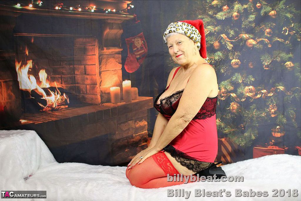 Horny grandmother produces a dildo after baring her huge tits at Christmas porn photo #422876903