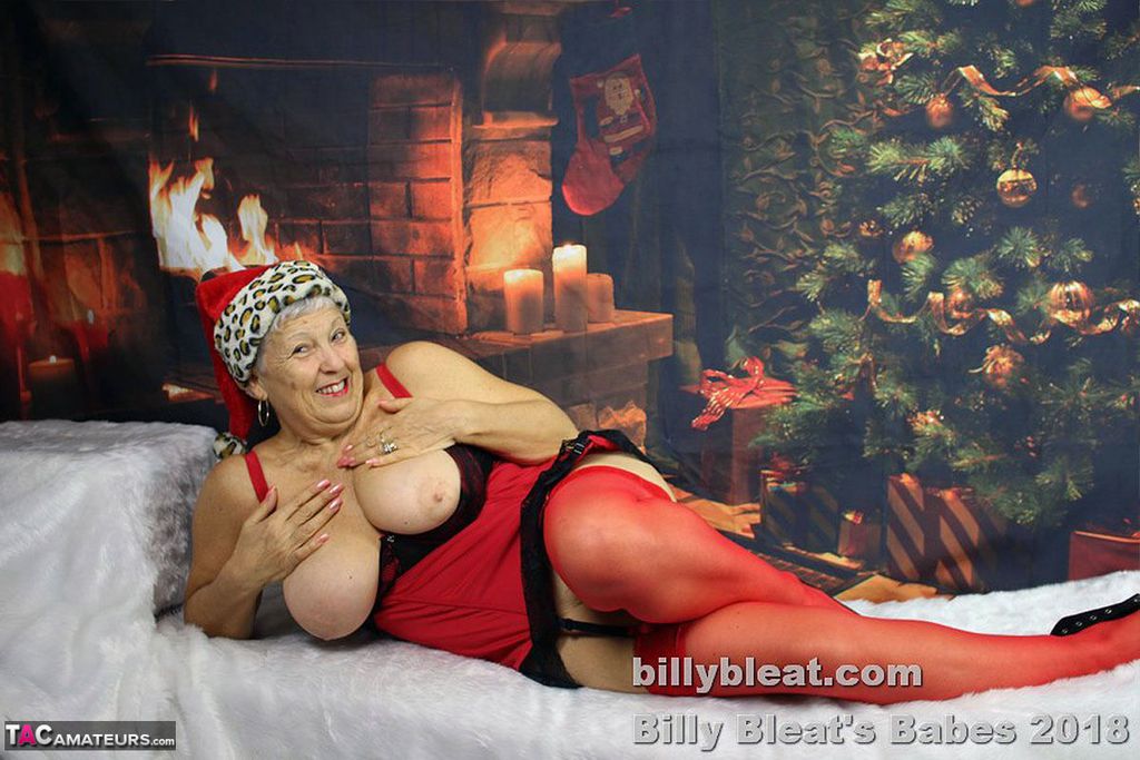 Horny grandmother produces a dildo after baring her huge tits at Christmas porn photo #422877077