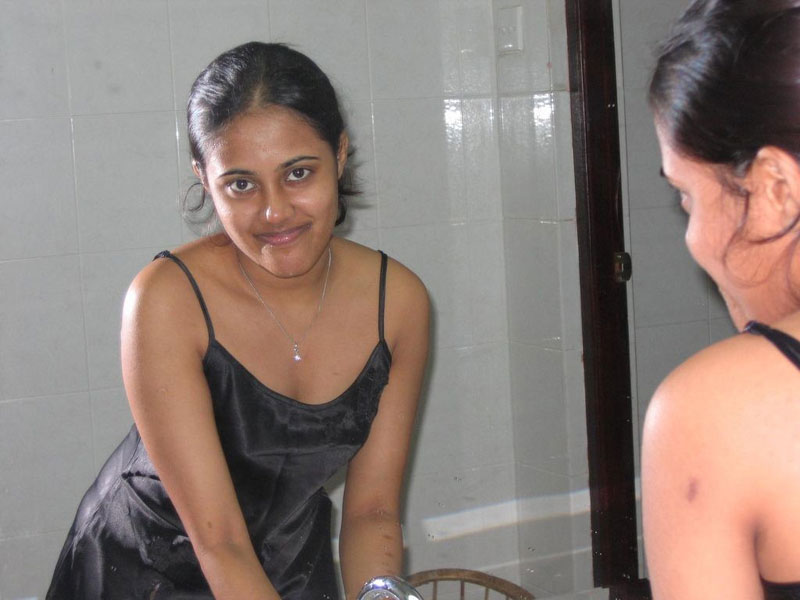 Indian girl with a nice smile shows her breasts on top of a bed foto porno #425059249
