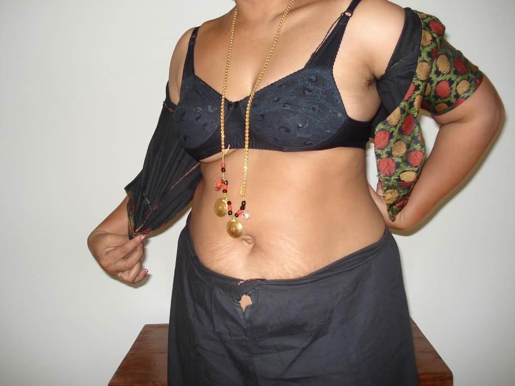 Then an overweight indian woman takes a seat after stripping off her clothes.