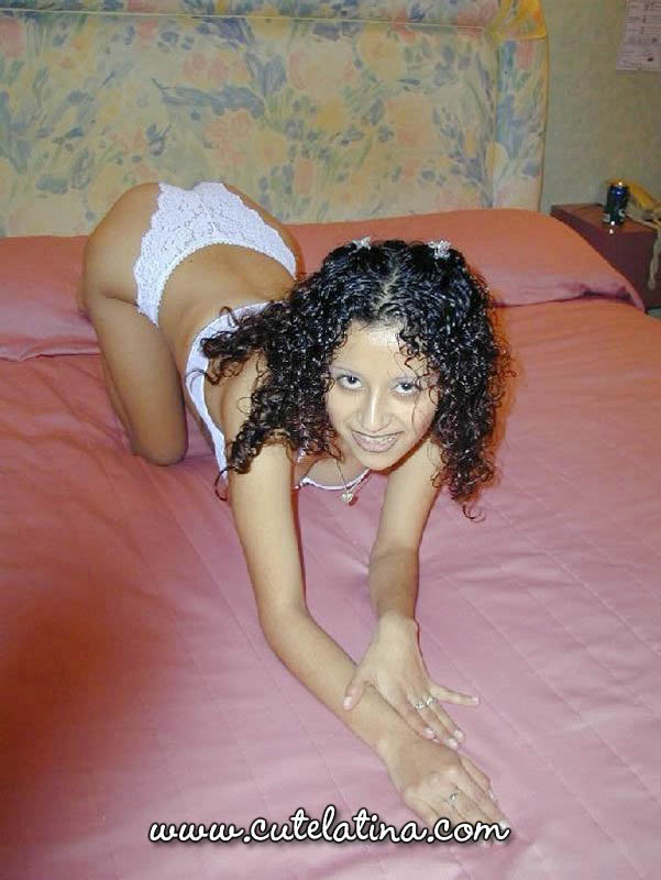 Latina girl with curly hair shows her bare ass on top of a bed foto porno #425220208
