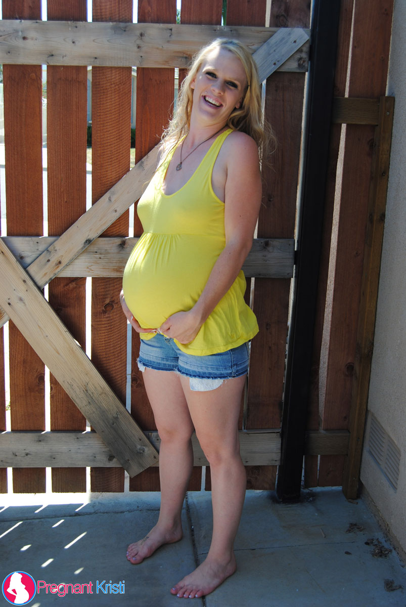 Pregnant blonde amateur Kristi shows her swollen tits and belly by a gate porn photo #428606154
