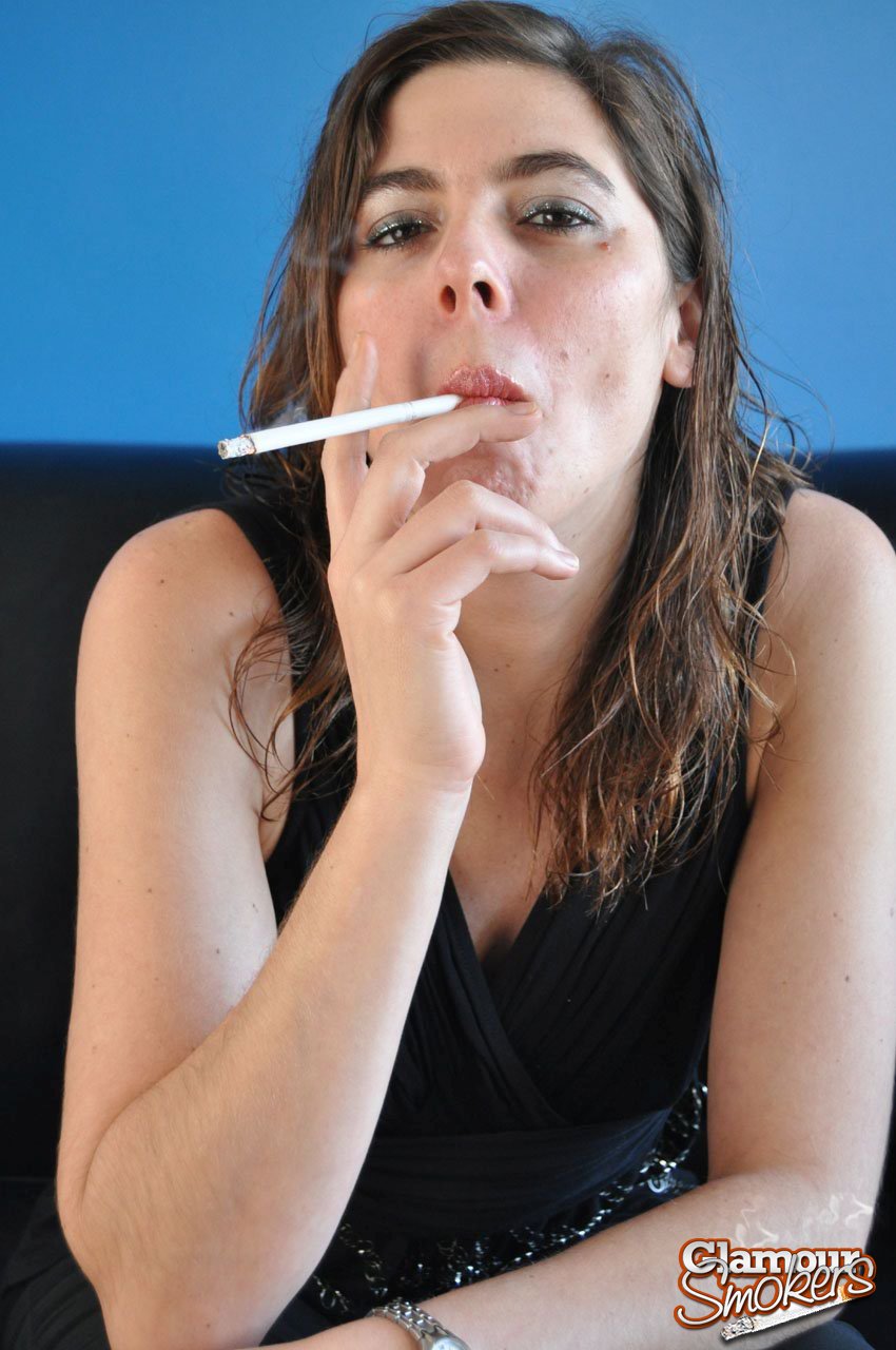 Solo girl strips to her underwear while smoking a cigarette foto porno #425458877