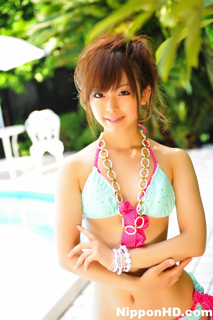 Adorable Japanese girl models a pretty bikini on a poolside patio porn photo #424561705