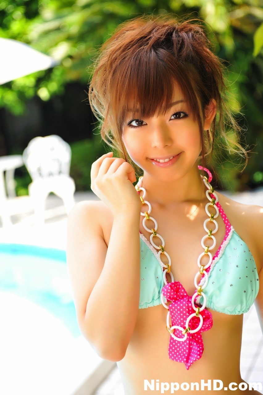 Adorable Japanese girl models a pretty bikini on a poolside patio porno foto #424653448