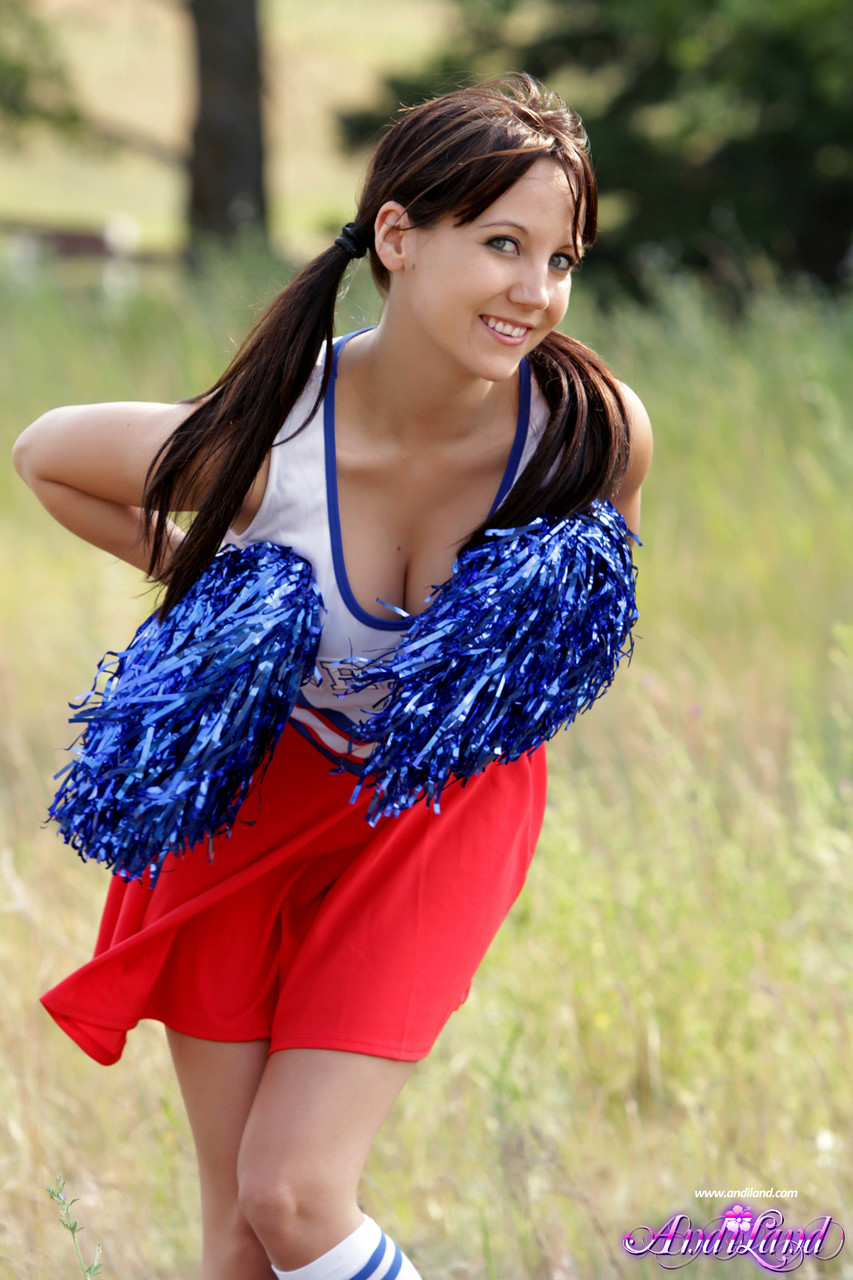 Teen cheerleader Andi Land exposes her tits and pussy while in a field porn photo #422814321