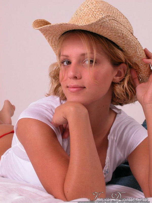 Young blonde Karen covers up her naked breasts with a straw hat in SFW action porno foto #426922529