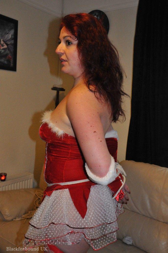 Redheaded solo girl shows her natural tits while restrained and gagged at Xmas porn photo #424917517