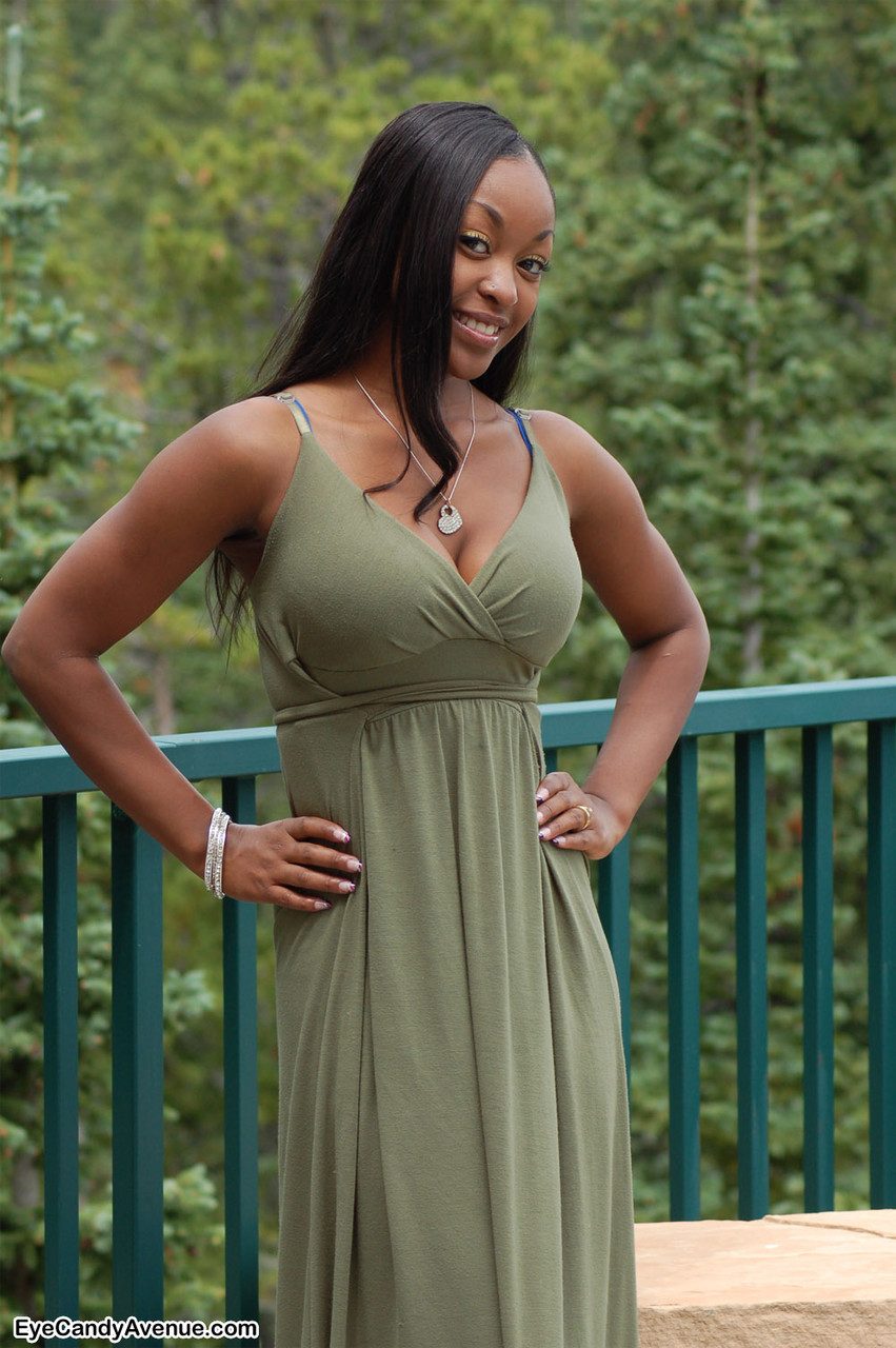 Ebony amateur Amber releases her big tits from a long dress on a balcony porn photo #424020646
