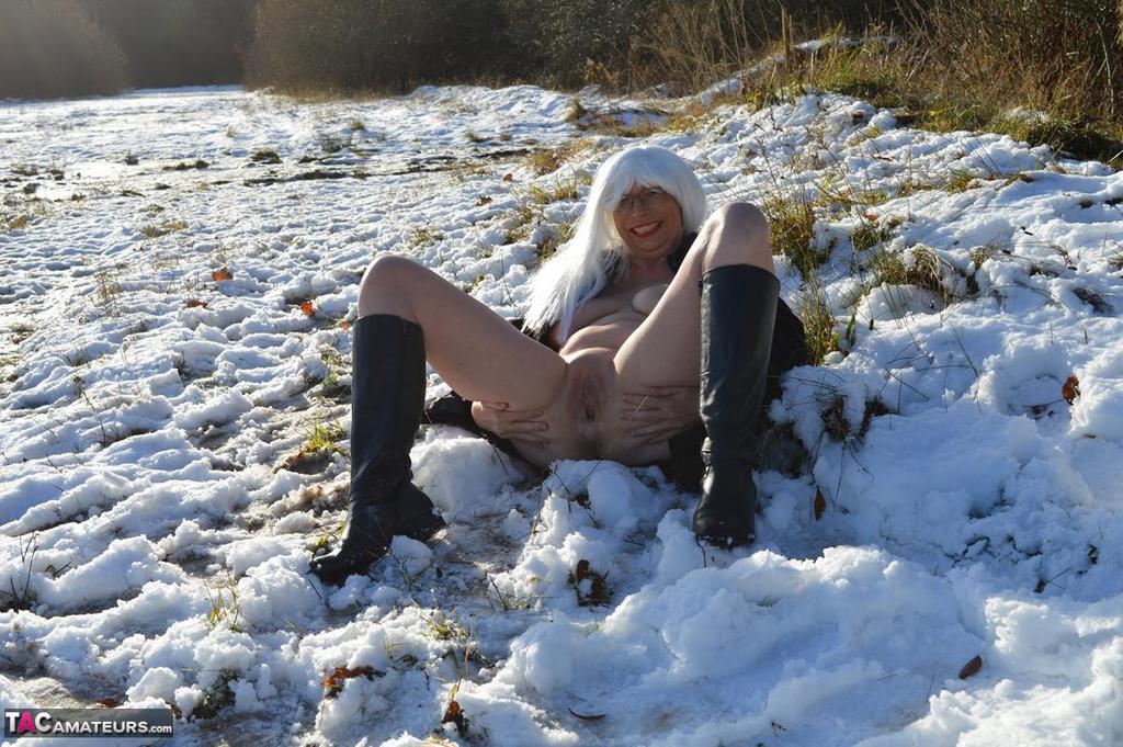 Mature platinum blonde gets naked on snow-covered ground in black boots photo porno #422941251