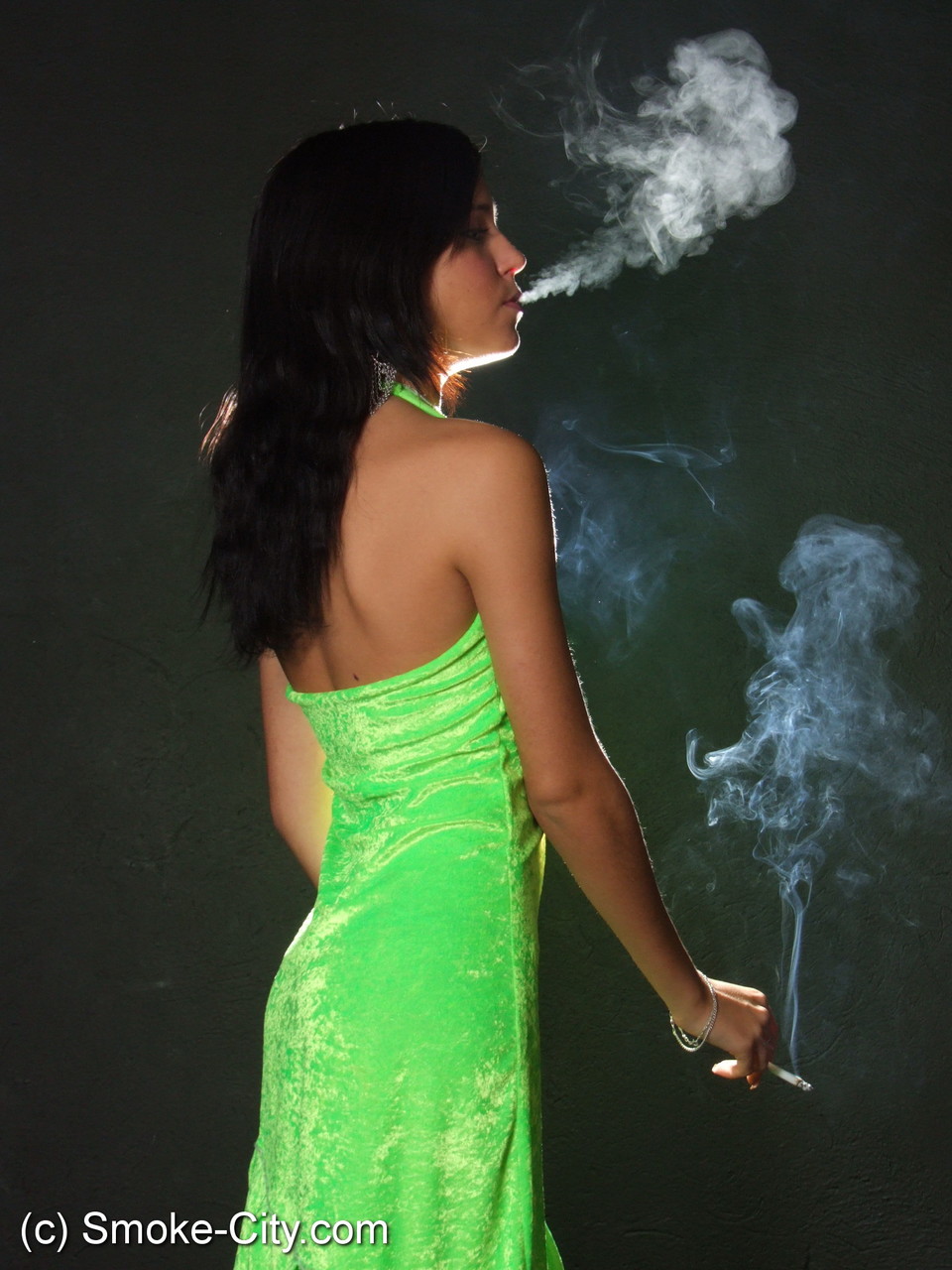 Dark haired teen wears a lime dress and pointy heels while smoking foto porno #426507733