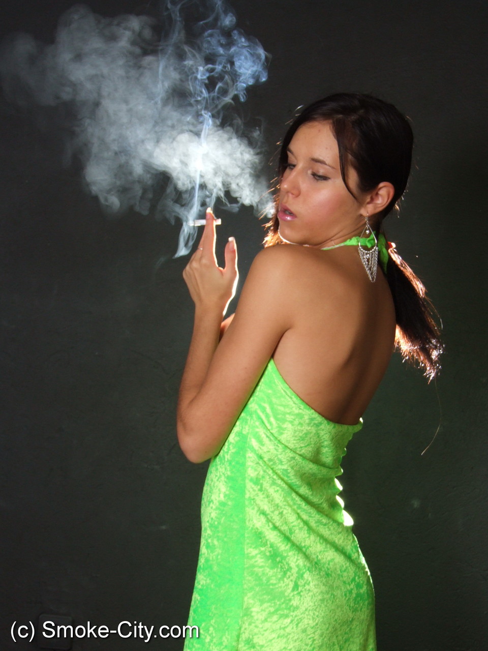 Dark haired teen wears a lime dress and pointy heels while smoking photo porno #426507737