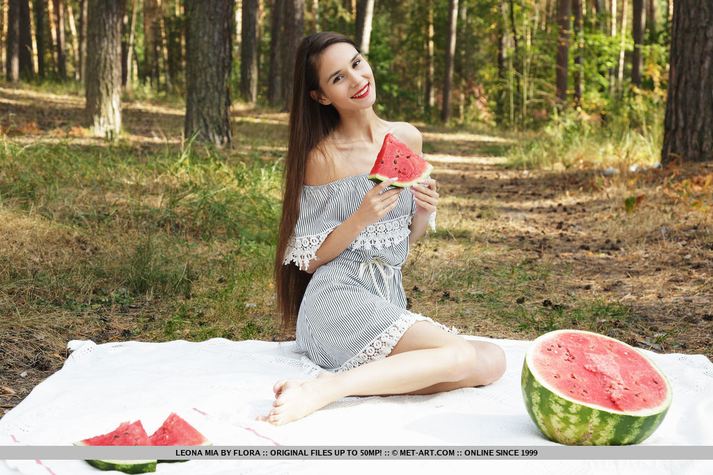 Skinny teen Leona Mia gets totally naked while eating a watermelon in a forest porn photo #427920525