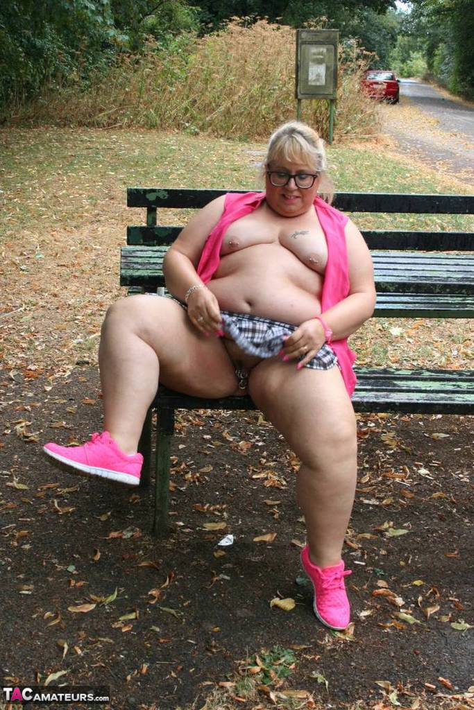 An unclothed Lexie Cummings, an obese British amateur athlete, exposes herself on a public picnic table.