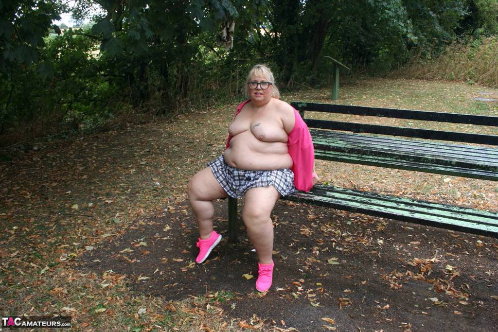 Lexie Cummings, an unclothed British amateur, exposes herself on a public picnic table.