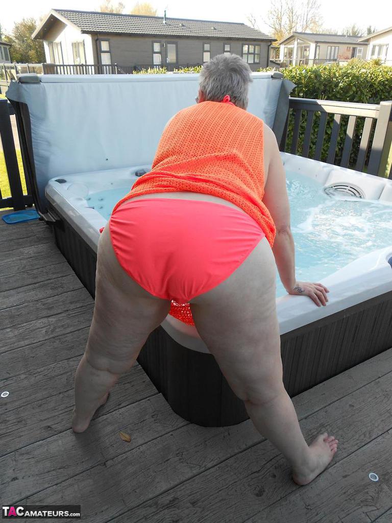 Fat nan bares her boobs while in a patio hot tub before getting naked on a bed foto porno #427541239
