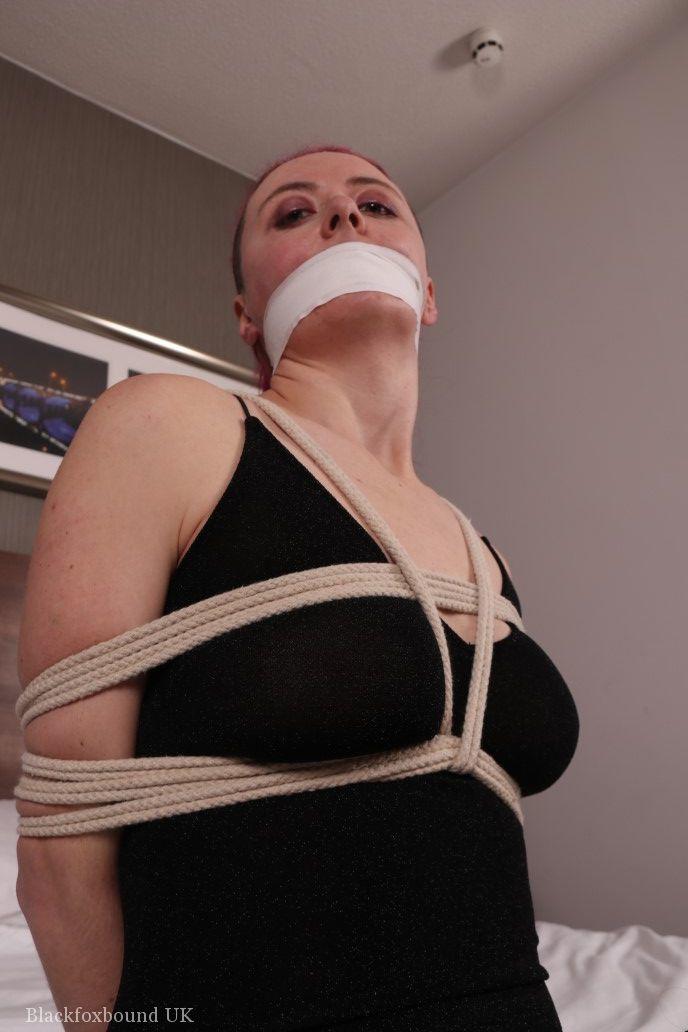 Fully clothed chick is tied up with ropes while silenced wit tape over mouth