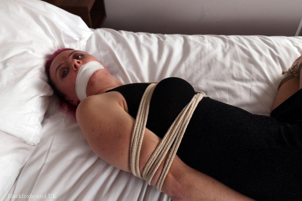 Fully clothed chick is tied up with ropes while silenced wit tape over mouth