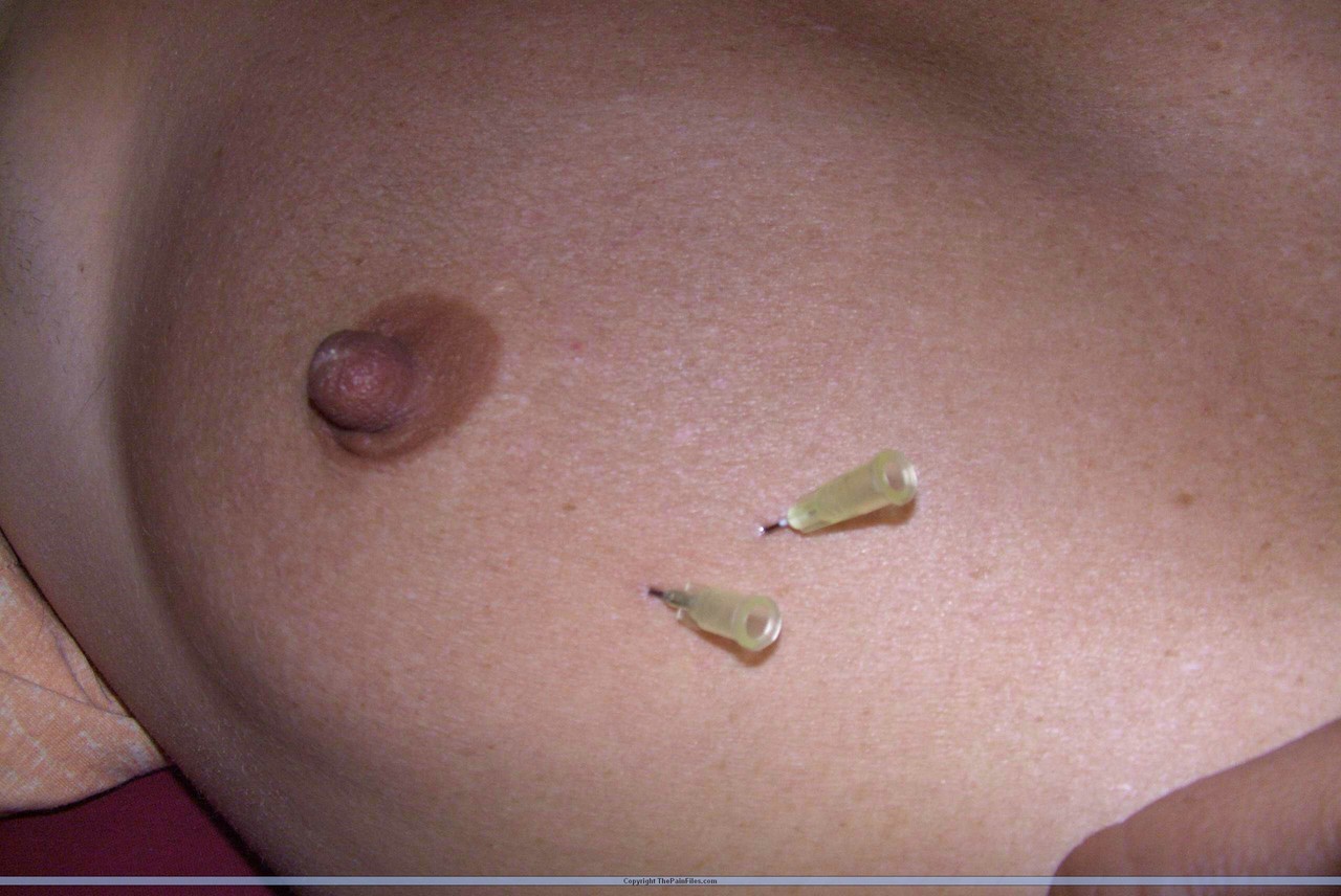 Close up action of a female having her breasts tortured with needles foto porno #427216356