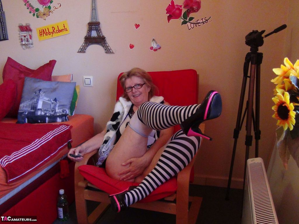Old amateur Abby Roberts bares her tits and twat in striped thigh high socks porn photo #426927368
