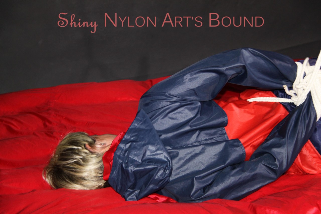 Sonja's seductive attire includes a bluered shiny nylon shorts and a bluered rain jacket.