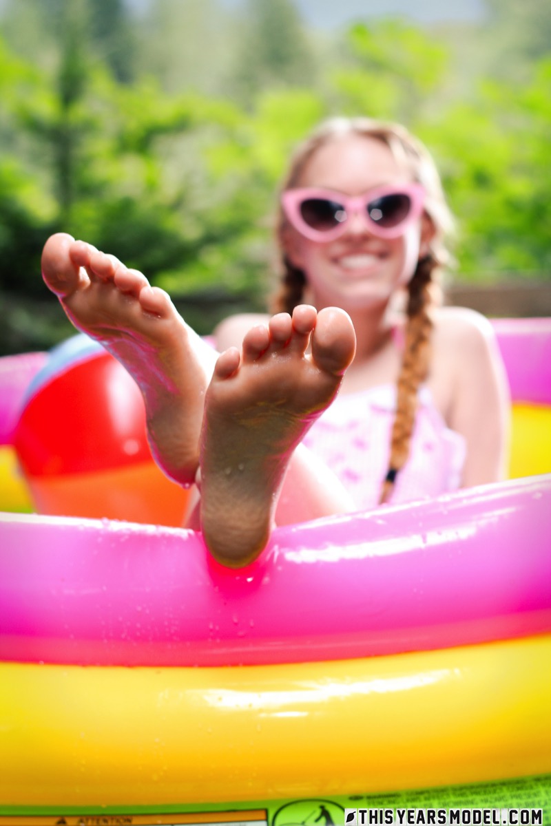 Adorable teen Dolly Little tugs on her braided pigtails in a blowup pool ポルノ写真 #425404134