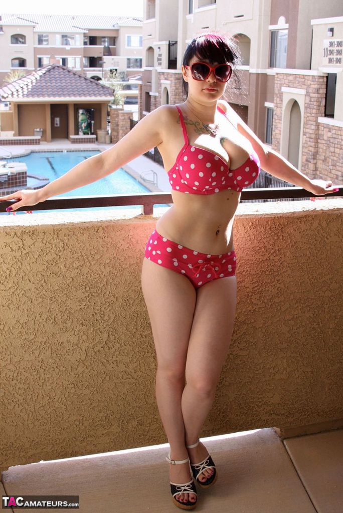 Amateur girl Susy Rocks models a polka-dot bikini in shades on a balcony porno foto #426957172