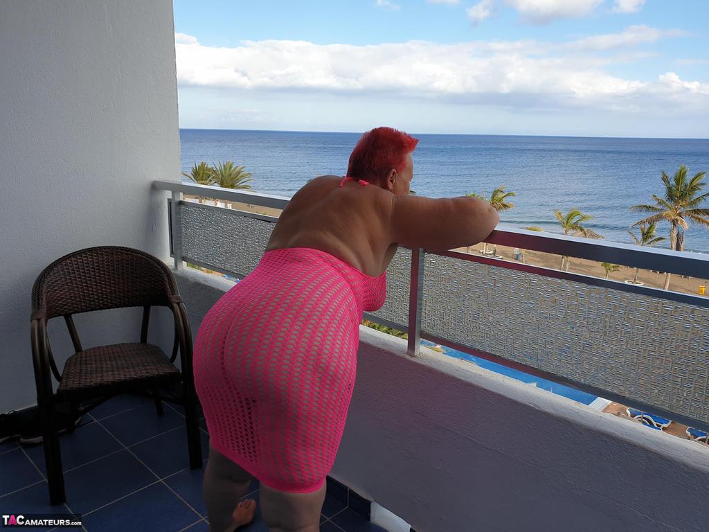 Fat Nan With Short Red Hair Finger Spreads Her Pussy On Oceanside Balcony
