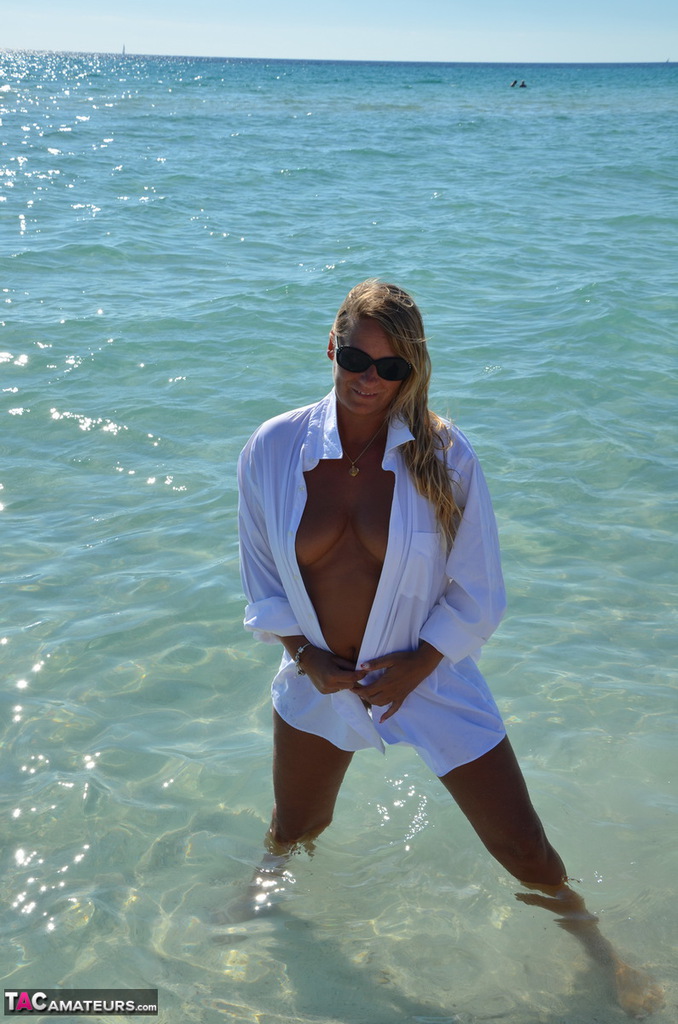 Blonde amateur Sweet Susi steps into the ocean while naked in a white shirt photo porno #424684882