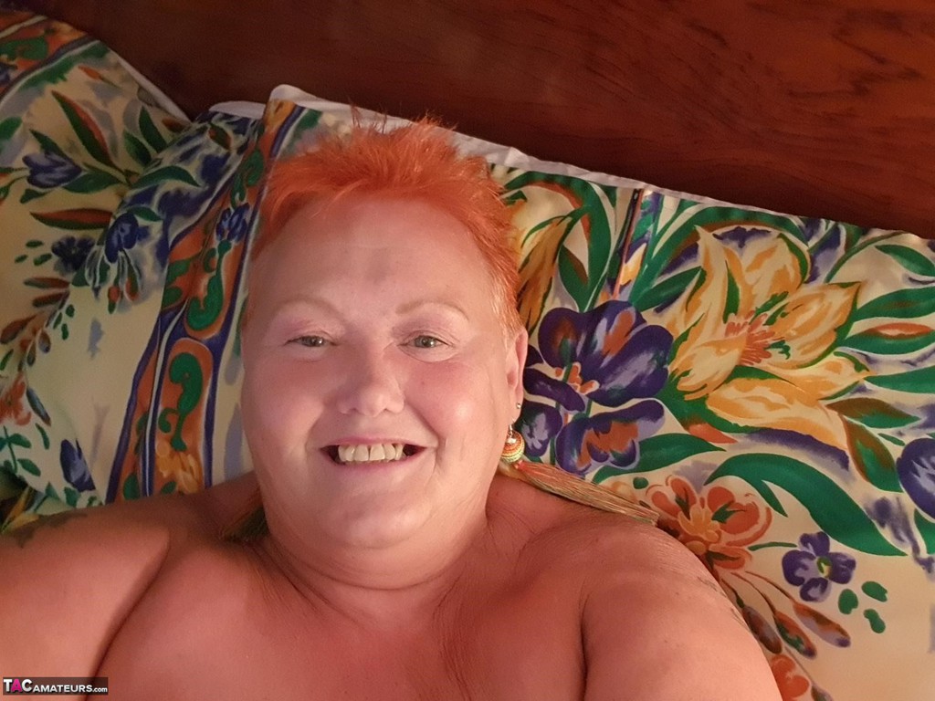 At home, a fat woman with red hair takes nude selfies and goes by the name Valgasmic Exposed.