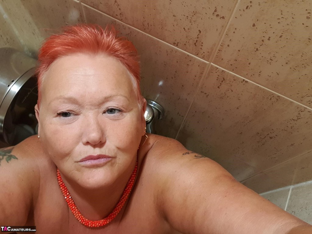 In her home, the fat woman with red hair is posing for nude selfies while on vacation at Valgasmic Exposed.
