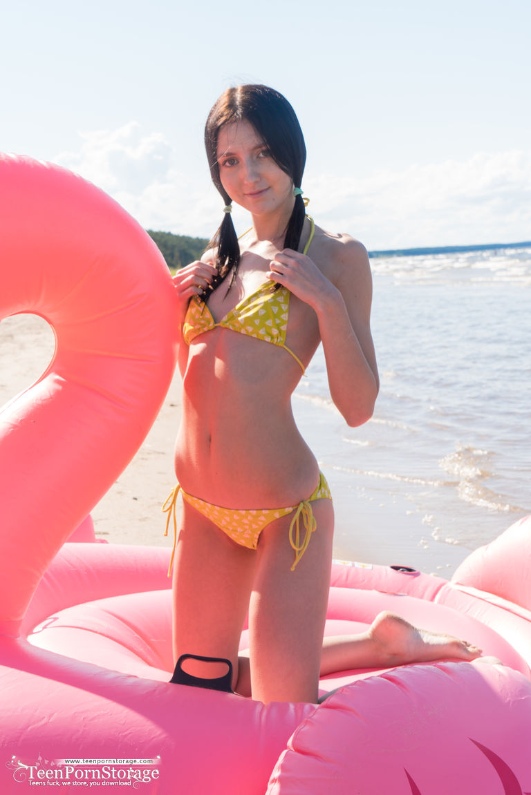 Girl next-door type doffs her bikini before finger fucking on an inflatable porn photo #427407752