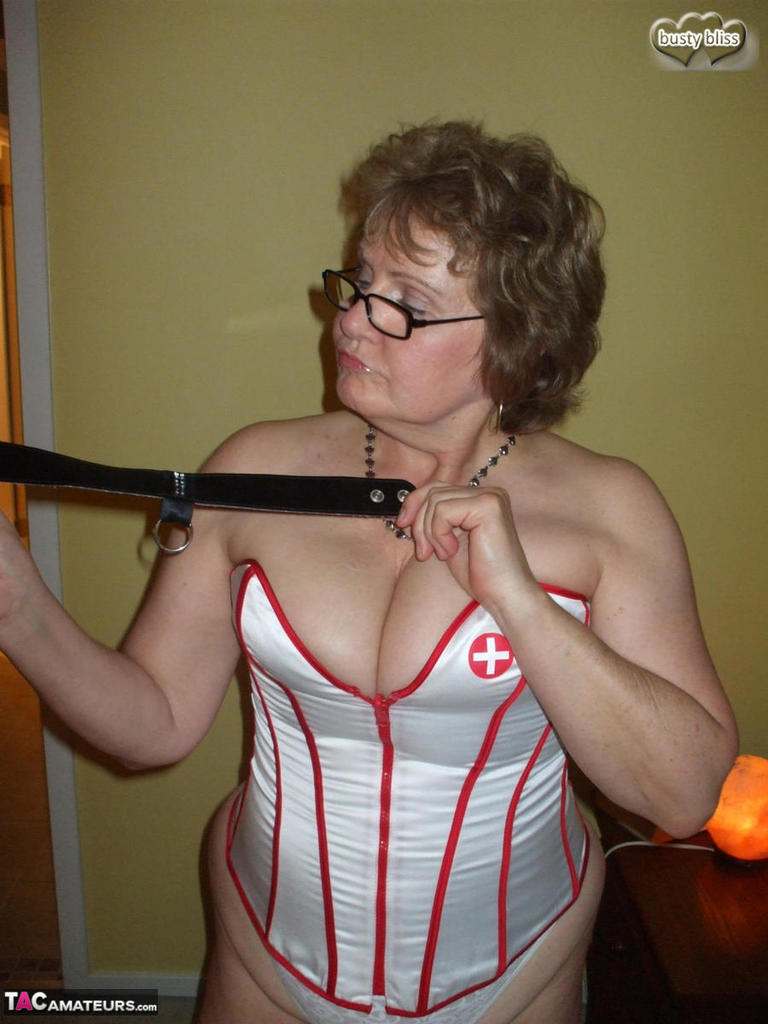 Older amateur Busty Bliss partakes in POV play while wearing a nurse's corset porn photo #423162883