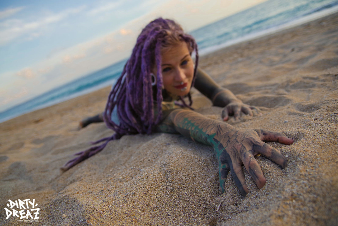 Heavily tattooed girl releases tiny tits from bikini top on a sandy beach 포르노 사진 #426703768