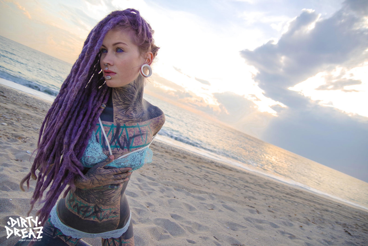 Heavily tattooed girl releases tiny tits from bikini top on a sandy beach porn photo #426703853