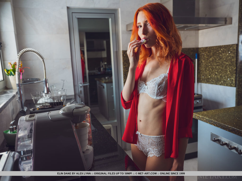 Over a hot drink, Elin Dane the young redhead goes completely naked on her bed.