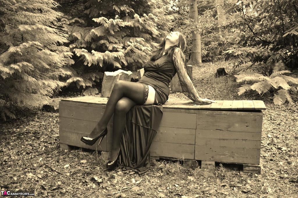 Goth girl Barby Slut bares her big tits and twat atop a casket in the woods foto porno #423239798