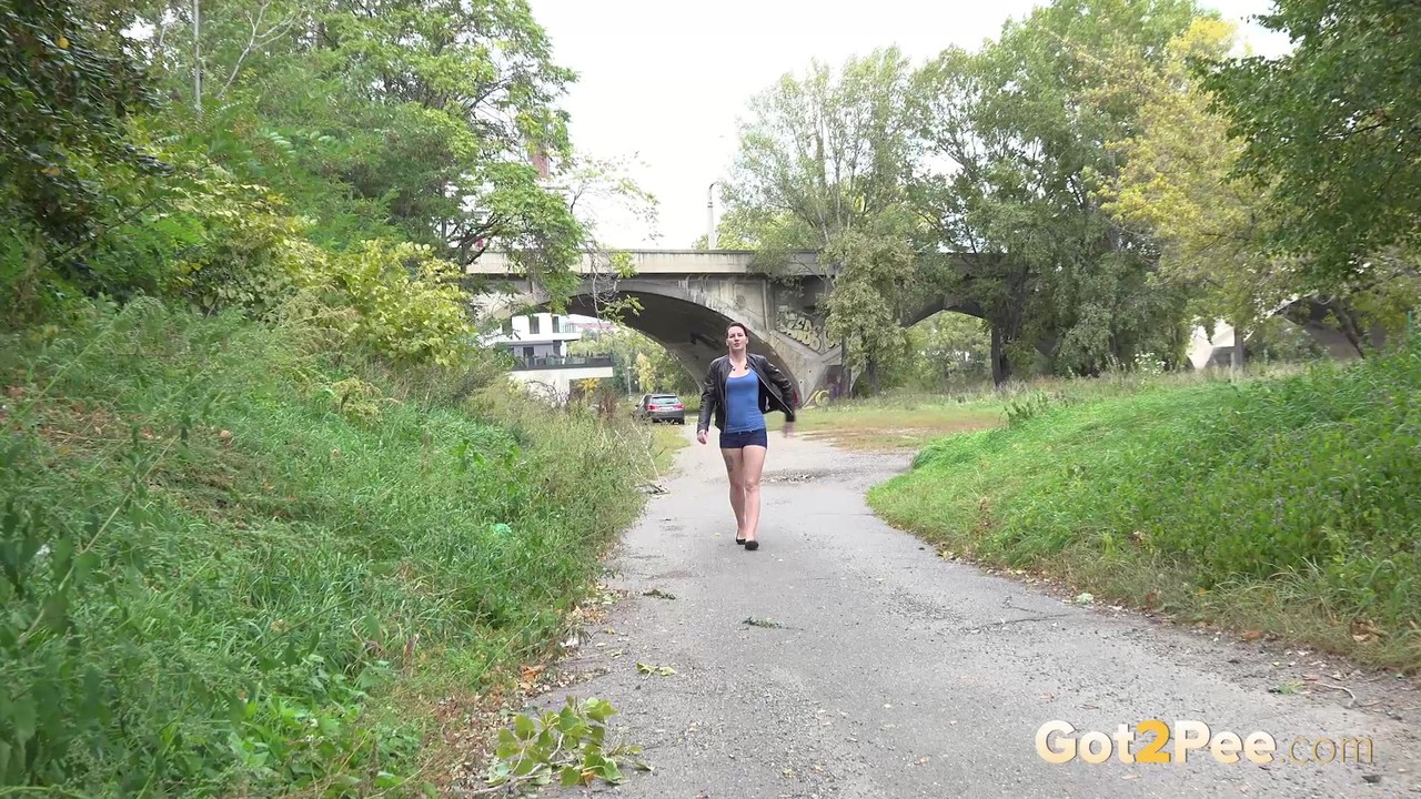 Leggy girl Amanda Hill pulls down shorts and panties for a pee on a paved path порно фото #426424236