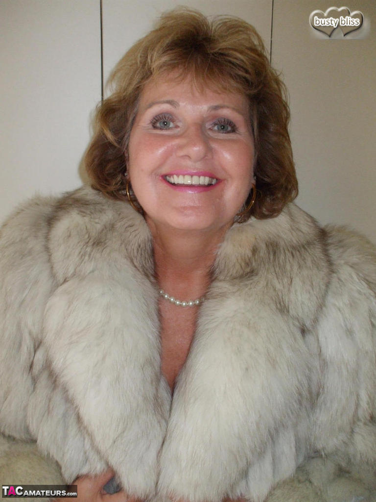 Older woman Busty Bliss licks her lips before showing her boobs in a fur coat porn photo #424683871
